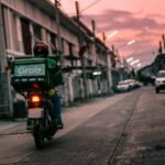 a person riding a motorcycle down a street